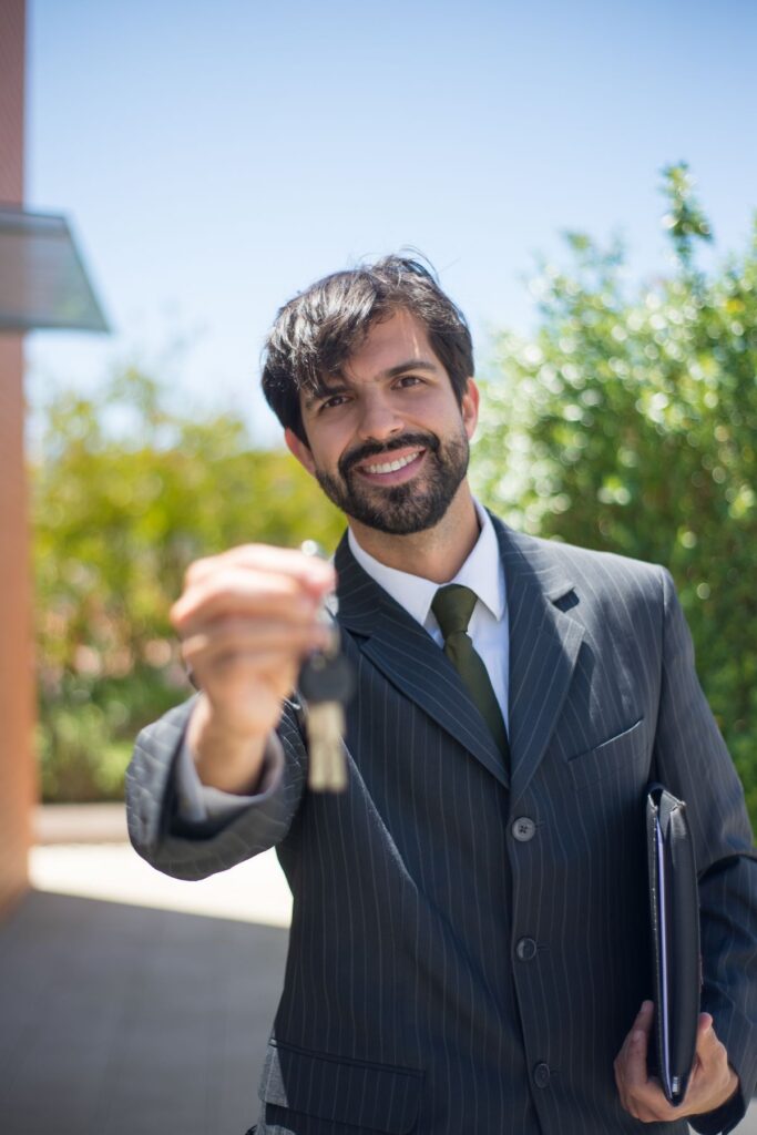 Real estate agent handing house keys